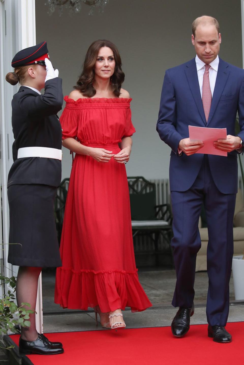 <p>The Duchess wore a maxi dress by Alexander McQueen <a href="https://www.townandcountrymag.com/society/tradition/g10295873/kate-william-royal-family-tour-germany-poland-2017/" rel="nofollow noopener" target="_blank" data-ylk="slk:to a garden party held in the Queen's honor;elm:context_link;itc:0;sec:content-canvas" class="link ">to a garden party held in the Queen's honor</a> while in Berlin during the royal tour. She paired the summery dress with scalloped sandals by Prada. </p>