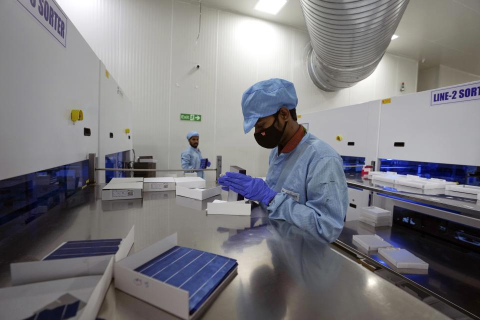 A worker packs cells at Premier Energies Solar on the outskirts of Hyderabad, India, Wednesday, Jan. 25, 2023. Solar developers in India fear that a tax meant to encourage Indian manufacture of solar components will slow down the installation of solar power this year. (AP Photo/Mahesh Kumar A.)