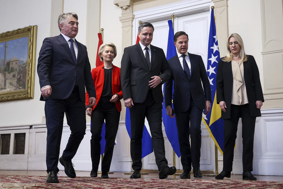 Members of the Bosnian Presidency Zeljko Komsic, left, Denis Becirovic, center and Zeljka Cvijanovic, right, walk to the meeting with European Commission President Ursula von der Leyen, 2nd left and Prime Minister of the Netherlands, Mark Rutte, 2nd right, in Sarajevo, Bosnia, Tuesday, Jan. 23, 2024. (AP Photo/Armin Durgut)