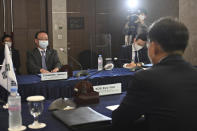 South Korea's Special Representative for Korean Peninsula Peace and Security Affairs Noh Kyu-duk, right, meets with Director-General of the Asian and Oceanian Affairs Bureau of the Ministry of Foreign Affairs of Japan Takehiro Funakoshi, left, during their bilateral meeting at a hotel in Seoul, Monday, June 21, 2021. (Jung Yeon-Je/Pool Photo via AP)
