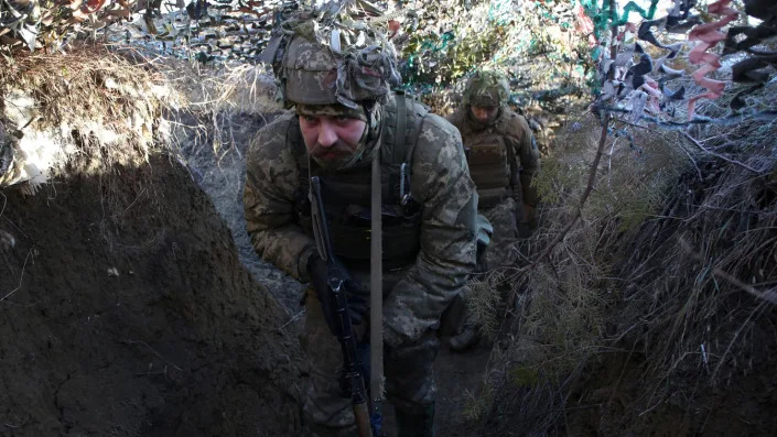 Ukrainian Military Forces servicemen walk on a trench on the frontline with Russia-backed separatists near to Avdiivka, Donetsk,  southeastern Ukraine.