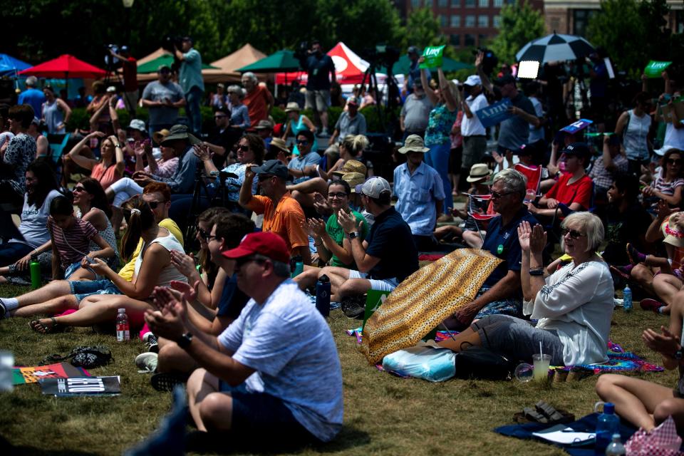 People gather outside of New Bo City market to listen to 10 presidential candidates speak during at the annual Progress Iowa Corn Feed on Sunday, July 14, 2019, in Cedar Rapids.