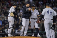 New York Yankees manager Aaron Boone speaks with infielders during a pitching change in the sixth inning of an American League Wild Card playoff baseball game against the Boston Red Sox at Fenway Park, Tuesday, Oct. 5, 2021, in Boston. (AP Photo/Charles Krupa)