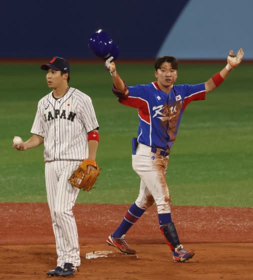 South Korea outfielder Hae Min Park celebrates next to Japan infielder Tetsuto Yamada