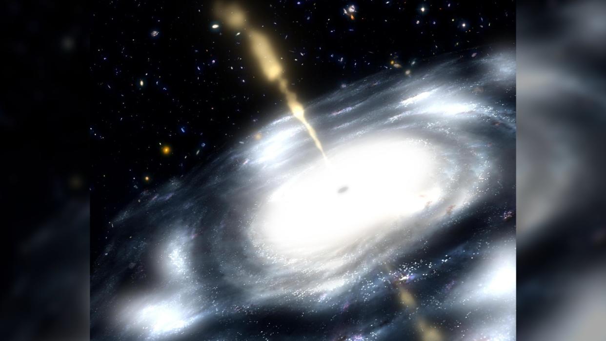  This artist concept shows a galaxy with a supermassive black hole at its core. The black hole is shooting out jets of radio waves. 