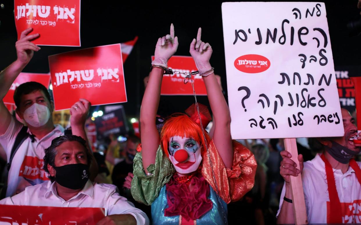 Protesters take part in a self-employed business owners demonstration against the Israeli government in Rabin square in Tel Aviv - Shutterstock