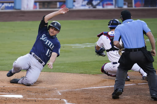 Seattle Mariners' Kyle Seager scores on a single from Austin Nola during the first inning of a baseball game against the Los Angeles Dodgers Monday, Aug. 17, 2020, in Los Angeles. (AP Photo/Marcio Jose Sanchez)