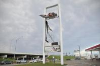 A signage of a gas station that was damaged by a tornado is seen in Oklahoma City, Oklahoma May 7, 2015. About a dozen people were injured by a series of tornadoes that touched down southwest of Oklahoma City, part of a storm system that flattened structures and caused severe flooding in several Great Plain states, officials said on Thursday. REUTERS/Nick Oxford