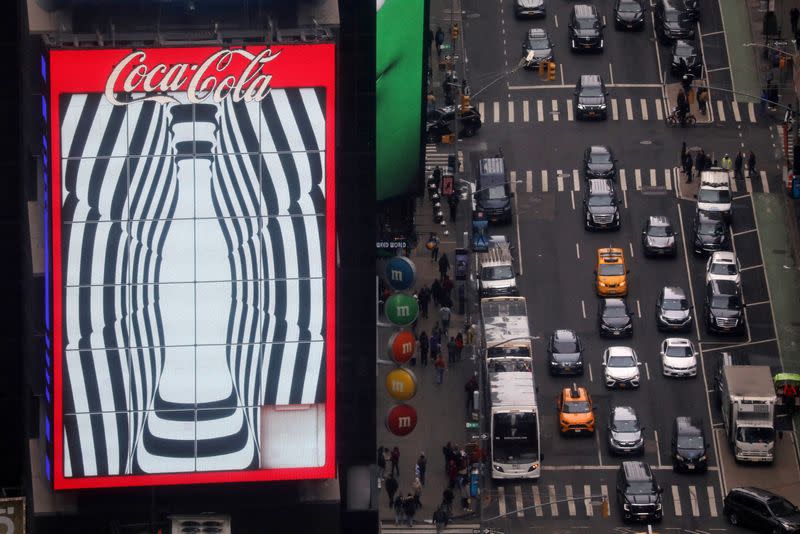 FILE PHOTO: Traffic passes a Coca-Cola digital billboard in the Times Square area of Manhattan