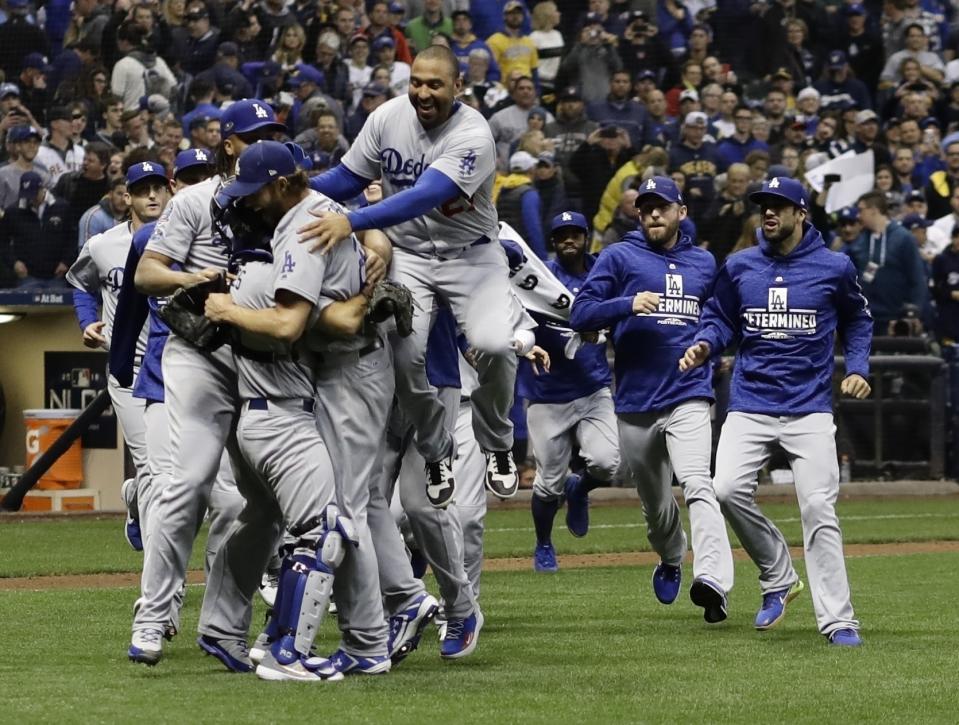 Los Dodgers de Los Ángeles festejan después de ganar el séptimo partido de la Serie de Campeonato de la Liga Nacional ante los Cerveceros de Milwaukee, el sábado 20 de octubre de 2018, en Milwaukee. Los Dodgers ganaron 5-1 para llevarse la serie. (AP Foto/Matt Slocum)