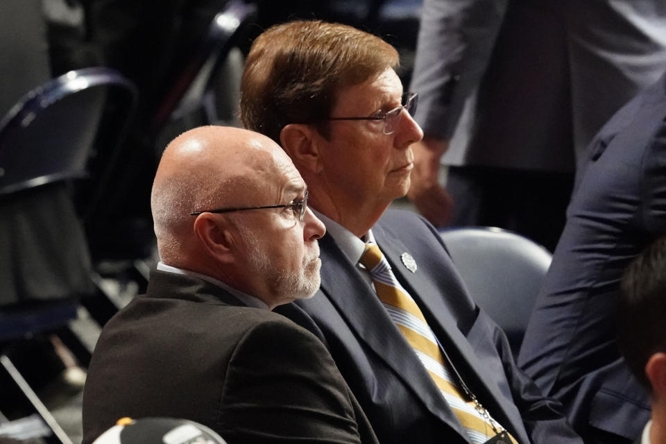 Nashville Predators new general manager Barry Trotz, front, and retiring general manager David Poile look on during the second day of the NHL hockey draft Thursday, June 29, 2023, in Nashville, Tenn. (AP Photo/George Walker IV)