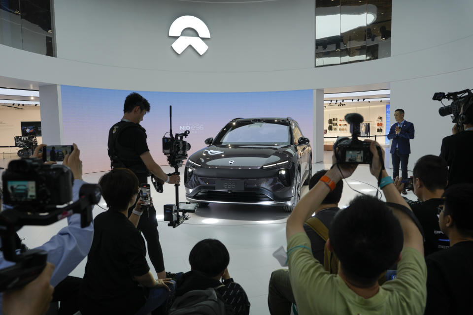 Journalists film the NIO es6, its new electric flagship SUV after unveiled by NIO Chairman William Li during the press day of the Auto Shanghai 2023 at the National Exhibition and Convention Center in Shanghai, China, Tuesday, April 18, 2023. Global and Chinese automakers plan to unveil more than a dozen new electric SUVs, sedans and muscle cars this week at the Shanghai auto show, their first full-scale sales event in four years in a market that has become a workshop for developing electrics, self-driving cars and other technology. (AP Photo/Ng Han Guan)