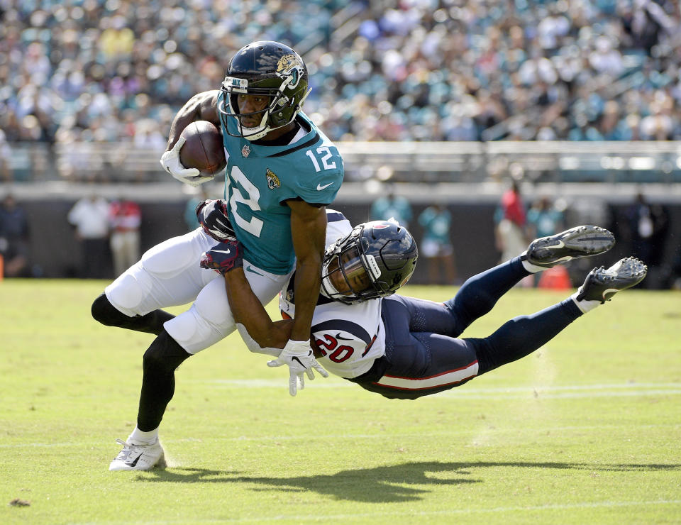 <p>Jacksonville Jaguars wide receiver Dede Westbrook (12) is stopped by Houston Texans defensive back Justin Reid (20) during the second half of an NFL football game, Sunday, Oct. 21, 2018, in Jacksonville, Fla. (AP Photo/Phelan M. Ebenhack) </p>