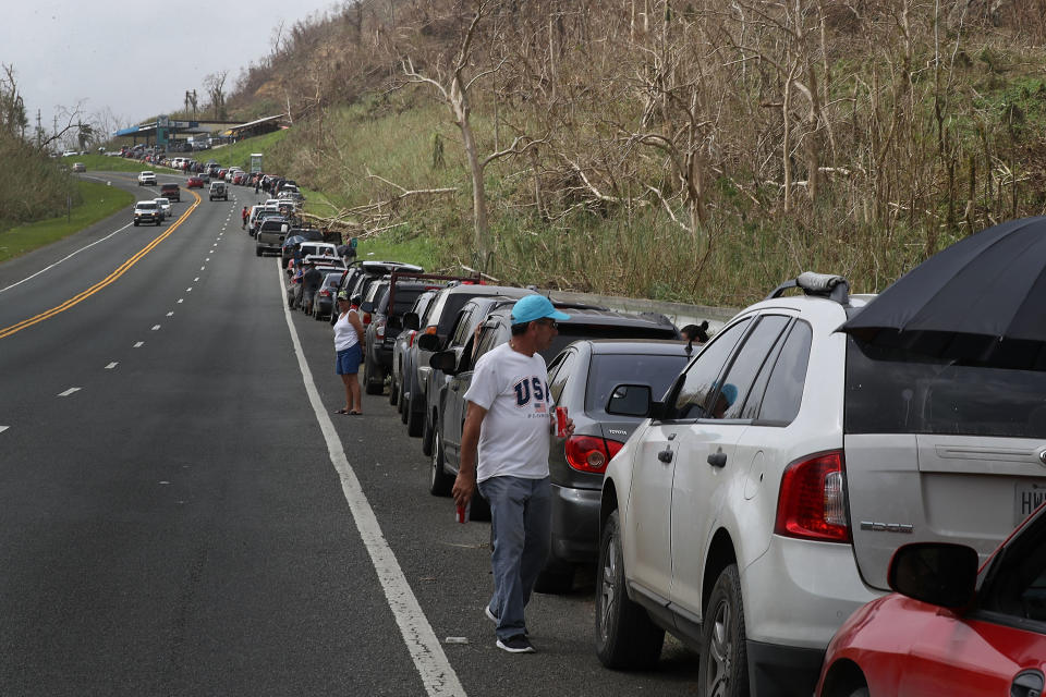 <p>People wait in line as they hope to fill up their vehicles with gas in the aftermath of Hurricane Maria on September 27, 2017 in Corozal, Puerto Rico. (Photo: Joe Raedle/Getty Images) </p>