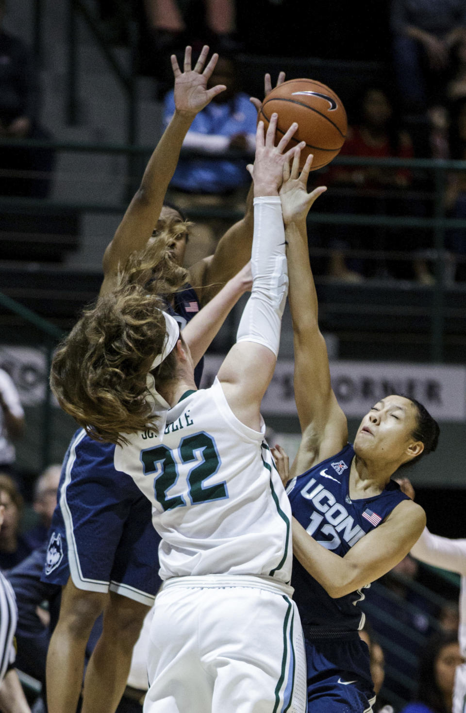 Tulane guard Meredith Schulte (22) and Connecticut guard Saniya Chong (12) jump for the ball during the first half of an NCAA college basketball game in New Orleans, Saturday, Feb. 18, 2017. (AP Photo/Sophia Germer)