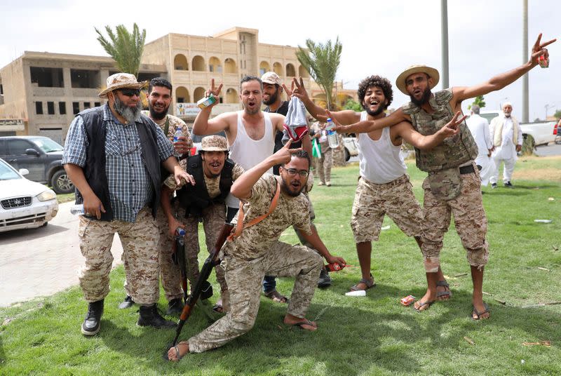 Fighters loyal to Libya's internationally recognised government celebrate after regaining control over Tarhouna city