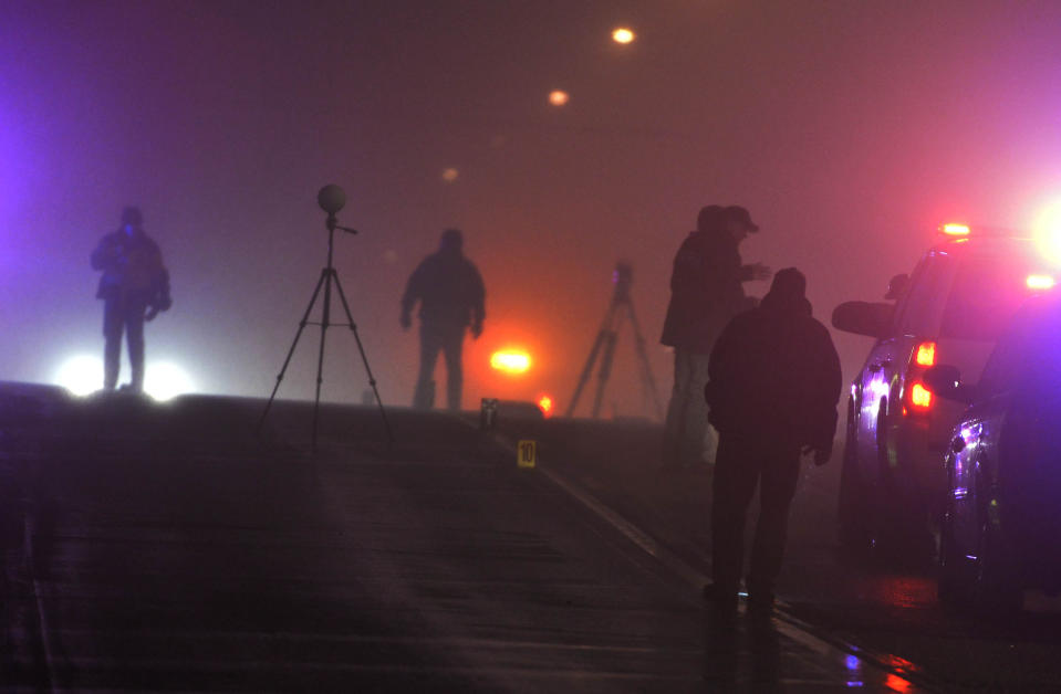 Law enforcement agents investigate a crime scene in Santaquin, Utah related to an officer-involved shooting, Thursday, Jan. 30, 2014. (AP Photo/The Salt Lake Tribune, Keith Johnson)