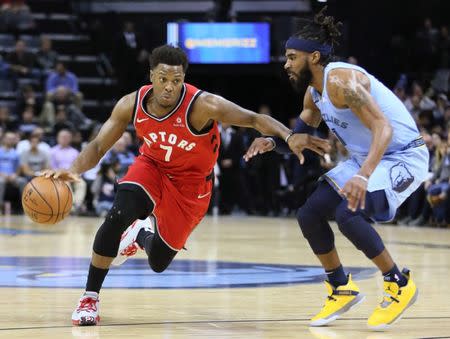 Nov 27, 2018; Memphis, TN, USA; Toronto Raptors guard Kyle Lowry (7) drives against Memphis Grizzlies guard Mike Conley (11) in the first half at FedExForum. Mandatory Credit: Nelson Chenault-USA TODAY Sports