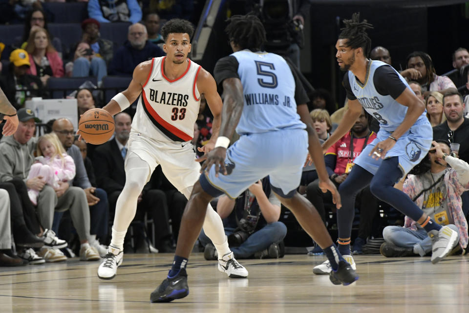 Portland Trail Blazers forward Toumani Camara (33) is defended by Memphis Grizzlies guard Vince Williams Jr. (5) and forward Ziaire Williams during the first half of an NBA basketball game Saturday, March 2, 2024, in Memphis, Tenn. (AP Photo/Brandon Dill)