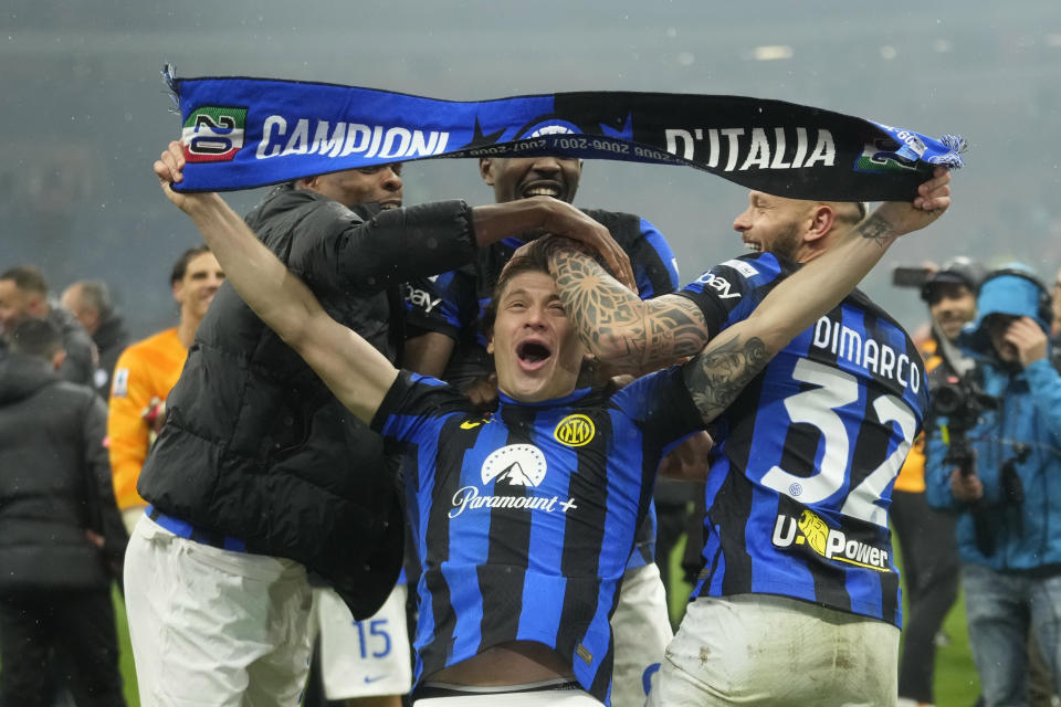 Inter Milan's Nicolo Barella, center, Inter Milan's Marcus Thuram, background and Inter Milan's Federico Dimarco, right, celebrate at the end of the Serie A soccer match between AC Milan and Inter Milan at the San Siro stadium in Milan, Italy, Monday, April 22, 2024. (AP Photo/Luca Bruno)