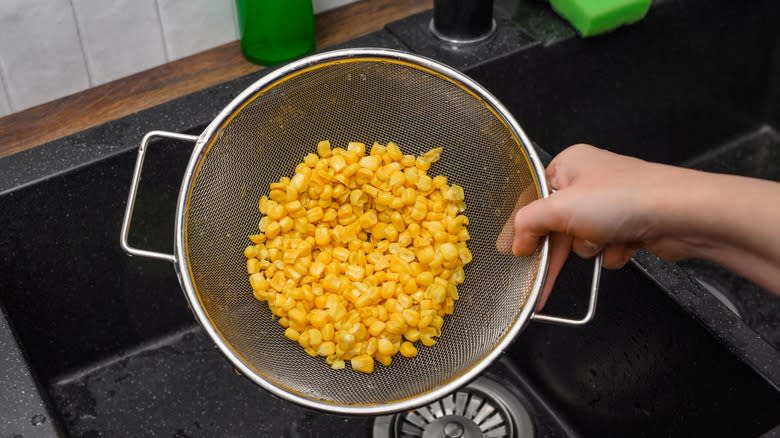 colander of corn in sink