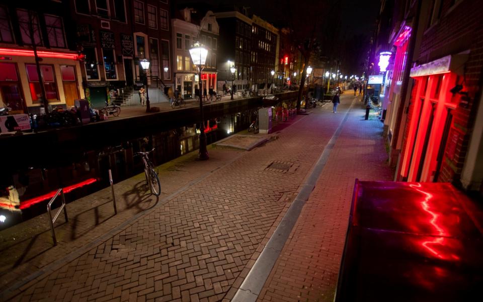 Amsterdam's red light district has been near-empty since the start of the country's 'intelligent' lockdown - Peter Dejong/AP