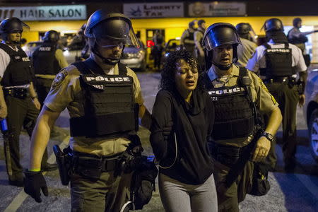 St Louis County police officers arrest an anti-police demonstrator in Ferguson, Missouri August 11, 2015. REUTERS/Lucas Jackson