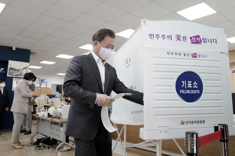 South Korean President Moon Jae-in casts his absentee ballot at a polling station for parliamentary election in Seoul