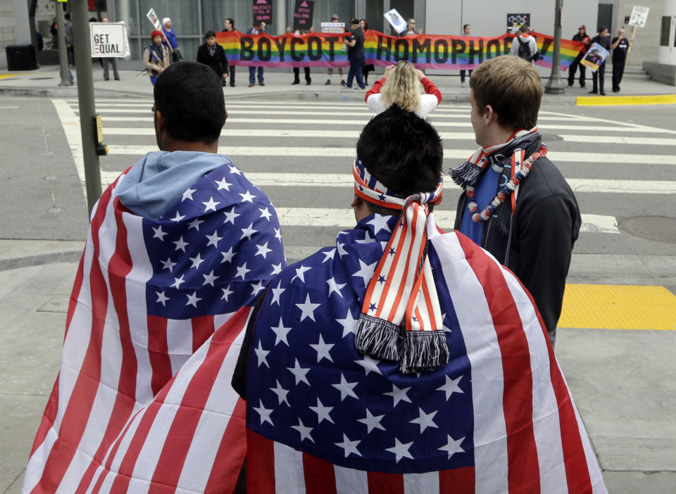 Demonstrators from a coalition of gay rights organizations, religious and political groups protest the treatment of gays in Russia, whose coastal city of Sochi hosts the 22nd Olympic Winter Games, outside the final stop of the "Road to Sochi," a traveling exhibit hosted by the U.S. Olympic Committee, at LALive in downtown Los Angeles Friday, Feb. 7, 2014. (AP Photo/Reed Saxon)