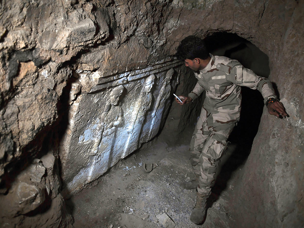 An Iraqi soldier can be seen exploring one of the recently found tunnels beneath the Prophet Jonah's shrine: Getty Images