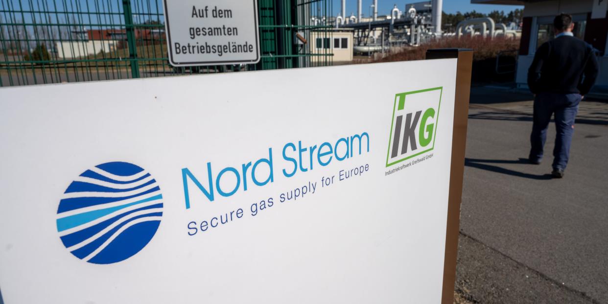 A sign with the words "Nord Stream" stands in front of the gas receiving station of the Nord Stream 1 Baltic Sea pipeline and the transfer station of the OPAL long-distance gas pipeline.