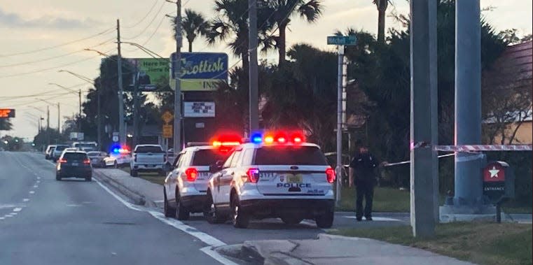 Police cordon off the Scottish Inn on Philips Highway where officers shot a suspect who would later die.