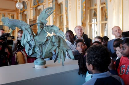 The iconic copper rooster, which was perched at the top of the spire of Notre-Dame Cathedral for more than a century is displayed at the exhibition "Revoir Notre-Dame de Paris\