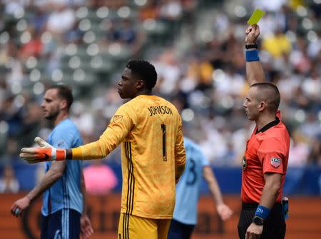 May 11, 2019; Carson, CA, USA; Match official Chris Penso issues a yellow card to Los Angeles Galaxy forward Zlatan Ibrahimovic (9) as New York City goalkeeper Sean Johnson (1) reacts during the second half at StubHub Center. Mandatory Credit: Gary A. Vasquez-USA TODAY Sports