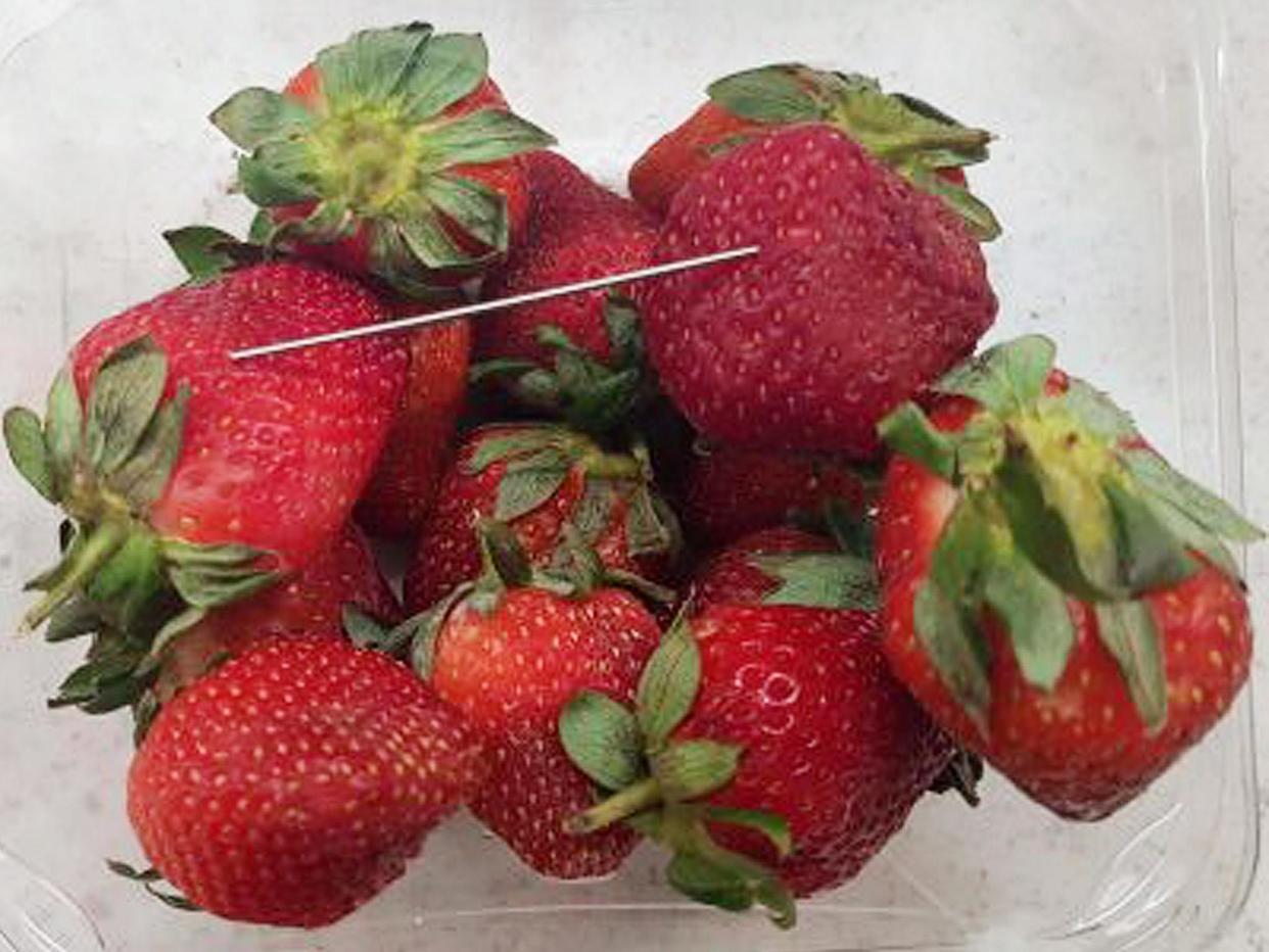 A woman has been charged after the nationwide alert over fruit laced with needles: EPA
