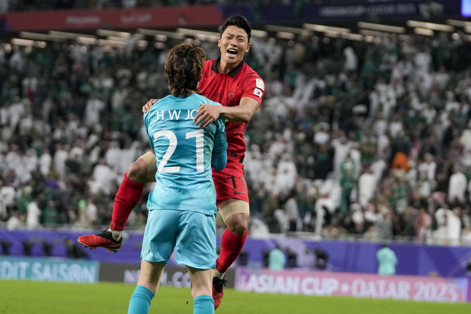 South Korea's Hwang Hee-Cha, right, celebrates with South Korea's goalkeeper Jo Hyeon-Woo after scores the winning penalty in a penalty shootout at the end of the Asian Cup Round of 16 soccer match between Saudi Arabia and South Korea, at the Education City Stadium in Al Rayyan, Qatar, Tuesday, Jan. 30, 2024. (AP Photo/Thanassis Stavrakis)