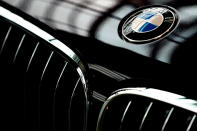 FILE- In this March 21, 2018, file photo, the logo of German car manufacturer BMW is pictured on a BMW 7 in Munich, Germany. Automakers Daimler and BMW are formally launching their joint venture in services that make it possible to use their cars without necessarily owning one. (AP Photo/Matthias Schrader, File)