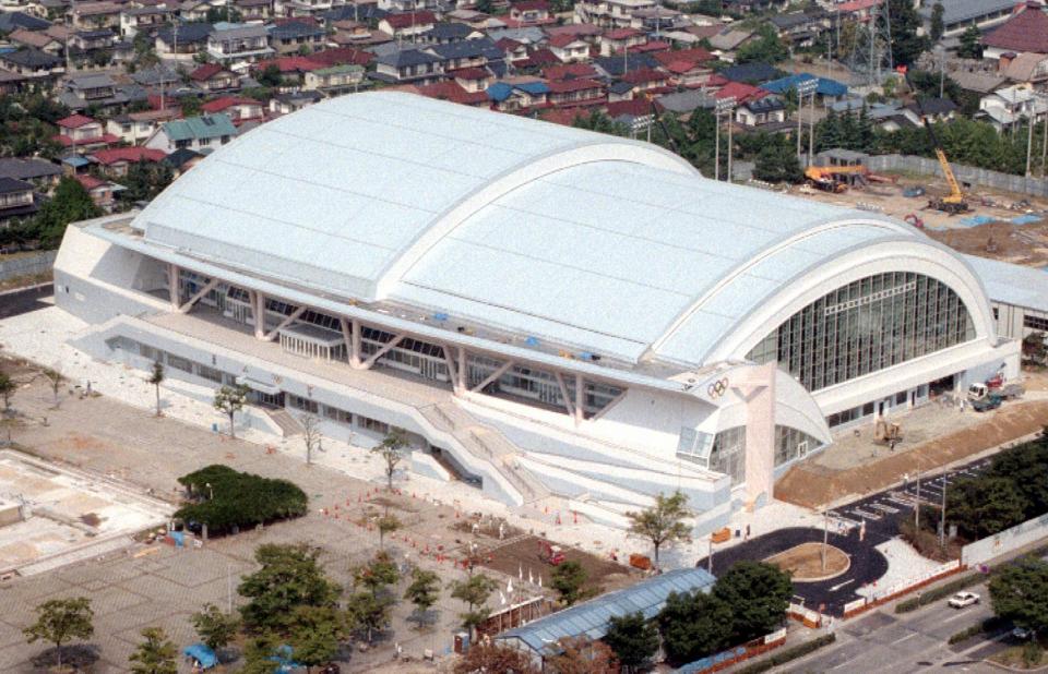 This Sept. 1997 photo shows the Aqua Wing Arena, ahead of the 1998 Winter Olympics in Nagano, central Japan. In Nagano, a city with a population of just 387,000, five large structures were built for the 1998 Winter Games. They are in use, but many say the venues are too big and costly to maintain for the size of the town. The Aqua Wing Arena has been converted into an aquatics center. (AP Photo/Kyodo News) JAPAN OUT