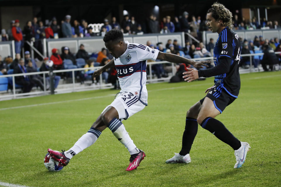 Vancouver Whitecaps defender Javain Brown, left, fends off San Jose Earthquakes forward Cade Cowell during the first half of an MLS soccer match in San Jose, Calif., Saturday, March 4, 2023. (AP Photo/Josie Lepe)