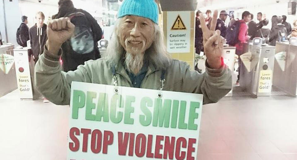 Lim wearing a sign calling for a stop to violence against women and children at a Sydney train station. Source: Facebook/ Danny’s Page