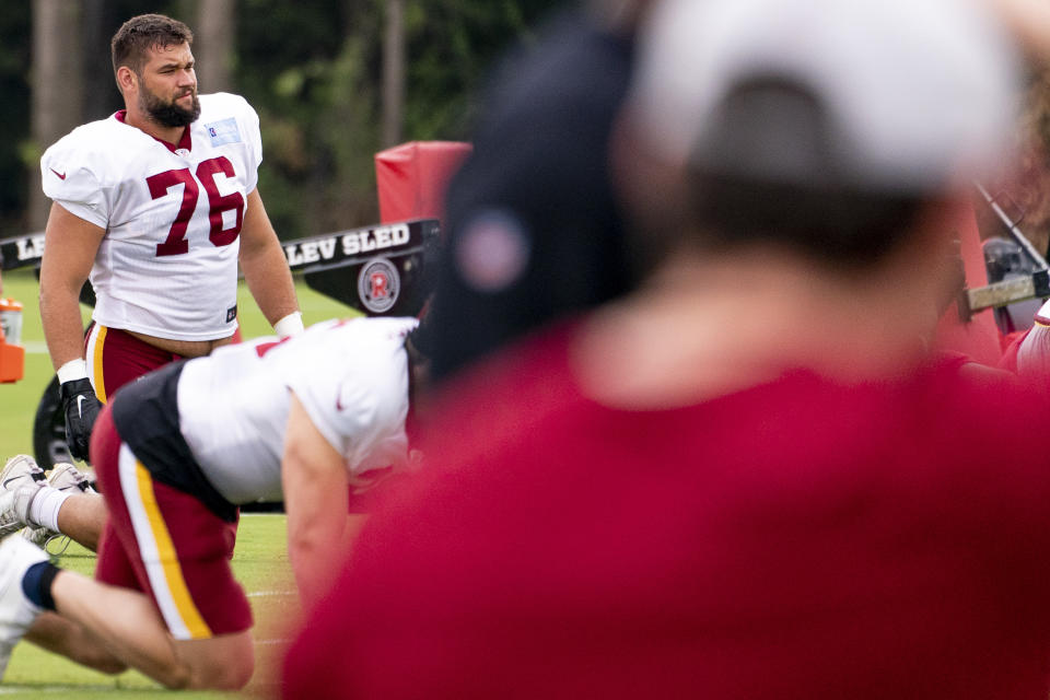 Washington Football Team offensive tackle Sam Cosmi (76) warms up at the team's NFL football training camp practice in Ashburn, Va., Tuesday, Aug. 3, 2021. (AP Photo/Andrew Harnik)