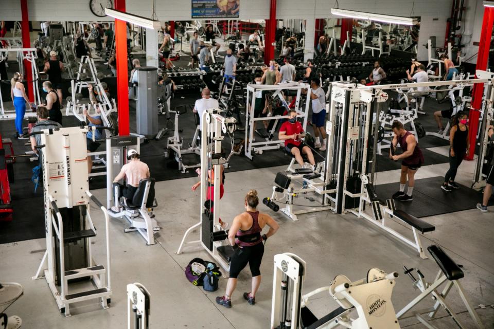 People work out inside Boulevard Fitness in San Diego in July.