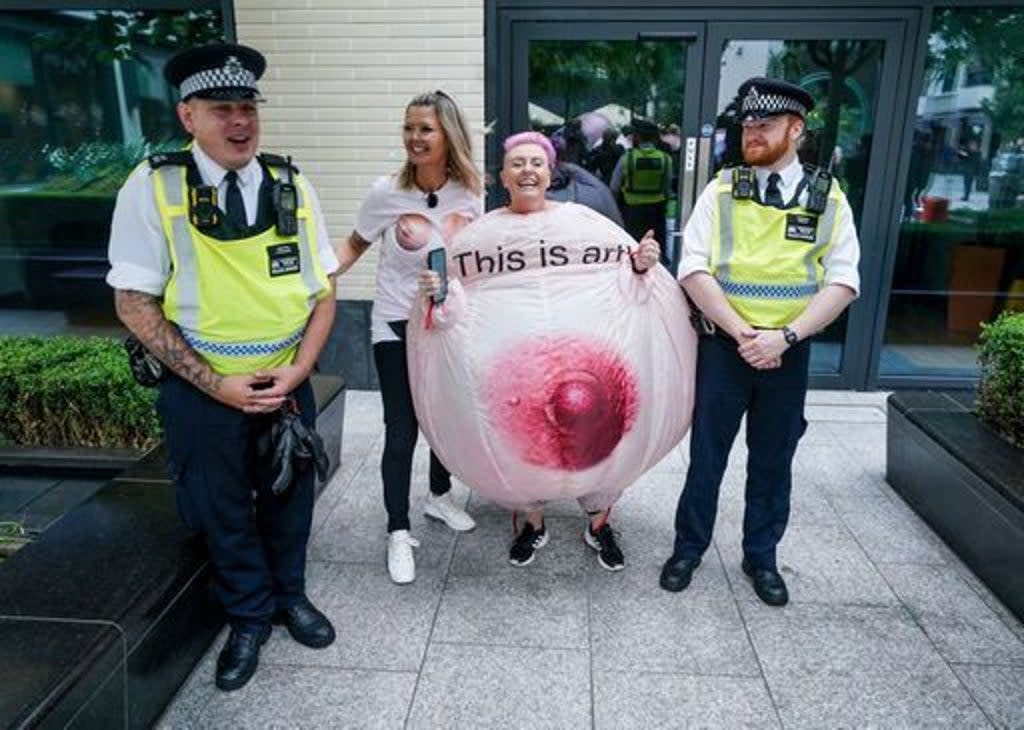 Protesters wearing inflatable breasts stand outside Facebook’s headquarters in central London (PA)