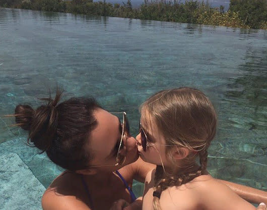 Victoria Beckham locks lips with Harper