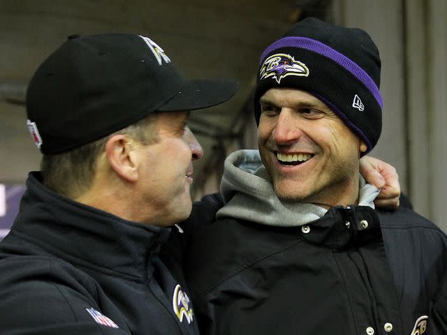 <p>Jamie Squire/Getty</p> Jim Harbaugh and John Harbaugh after the Ravens defeated the Pittsburgh Steelers 30-17 in their AFC Wild Card game at Heinz Field on January 3, 2015 in Pittsburgh, Pennsylvania.