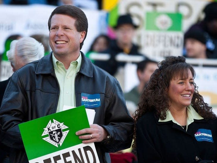 Jim Bob Duggar (L) and his wife Michelle Duggar (R), supporters of Republican presidential candidate and former Pennsylvania Senator Rick Santorum, attend a Pro-Life rally  in Columbia, South Carolina, on the steps of the State House in this file photo from January 14, 2012. REUTERS/Chris Keane/Files