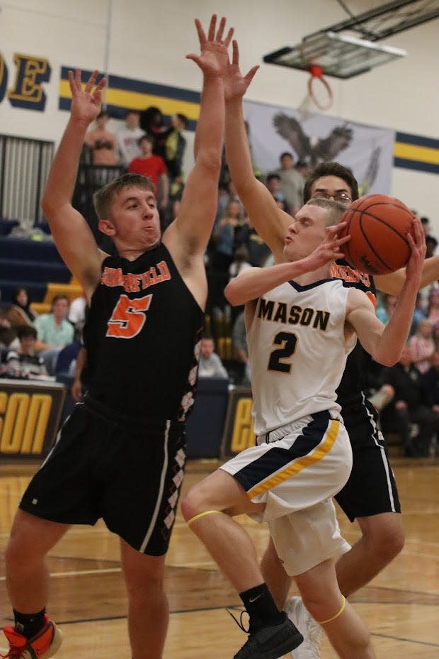 Carson Brown of Erie Mason goes to the basket against Summerfield’s Bryce Kalb during a 73-42 Mason win Thursday night.