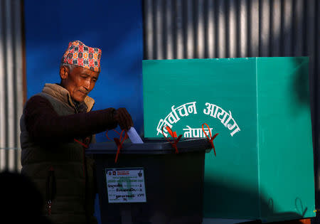 A man casts his vote in a ballot box during the parliamentary and provincial elections at Chautara in Sindhupalchok District November 26, 2017. REUTERS/Navesh Chitrakar