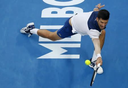 Tennis - Australian Open - Rod Laver Arena, Melbourne, Australia, January 22, 2018. Novak Djokovic of Serbia stretches for a shot against Chung Hyeon of South Korea. REUTERS/Thomas Peter