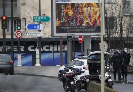 French intervention police are seen at the scene of a hostage taking at a kosher supermarket in eastern Paris January 9, 2015. REUTERS/Charles Platiau